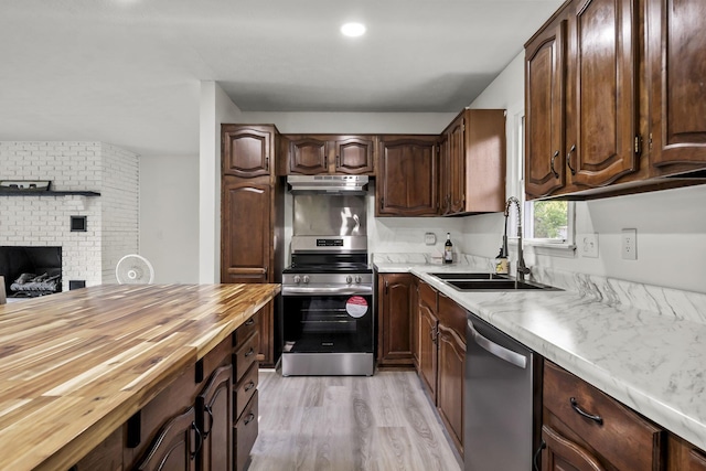 8149 Outville Rd SW, Pataskala, OH 43062 - kitchen featuring stainless steel appliances, under cabinet range hood, wooden counters, light wood-style floors, and dark brown cabinets
