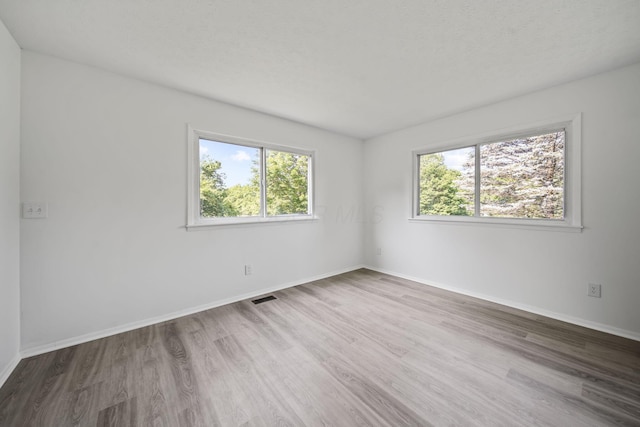 8149 Outville Rd SW, Pataskala, OH 43062 - empty room with plenty of natural light and wood finished floors