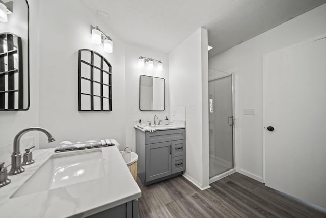8149 Outville Rd SW, Pataskala, OH 43062 - full bathroom with wood finished floors, a stall shower, and two vanities
