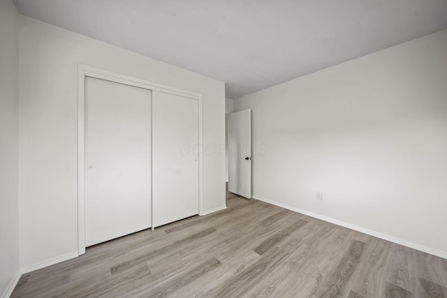 8149 Outville Rd SW, Pataskala, OH 43062 - unfurnished bedroom featuring wood finished floors and a closet