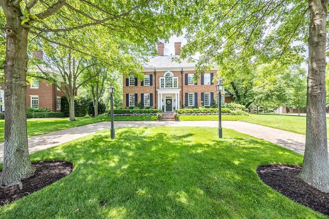 4791 Yantis Dr, New Albany, OH 43054 - georgian-style home with a chimney, brick siding, and a front lawn