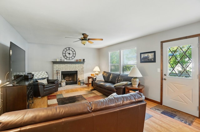 3383 Parkbrook Dr, Grove City, OH 43123 - living area with light wood finished floors, ceiling fan, and a brick fireplace