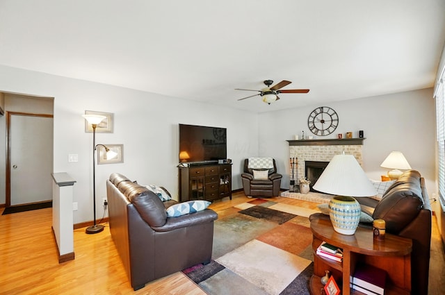 3383 Parkbrook Dr, Grove City, OH 43123 - living area with light wood-type flooring, a ceiling fan, and a brick fireplace