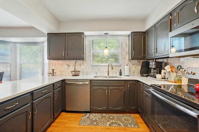 3383 Parkbrook Dr, Grove City, OH 43123 - kitchen featuring appliances with stainless steel finishes, light wood-type flooring, tasteful backsplash, and light countertops