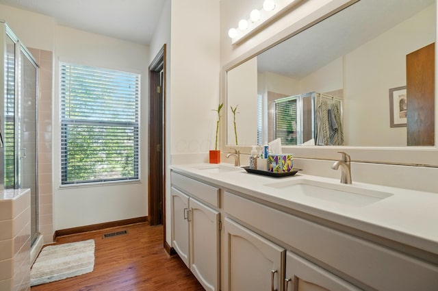 3383 Parkbrook Dr, Grove City, OH 43123 - bathroom with a stall shower, double vanity, and wood finished floors