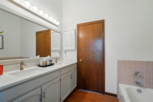 3383 Parkbrook Dr, Grove City, OH 43123 - bathroom featuring double vanity, a bath, and wood finished floors