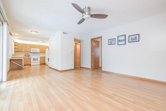 129 Chase Ave Unit 102L, Russells Point, OH 43348 - unfurnished living room featuring light wood-style flooring and a ceiling fan
