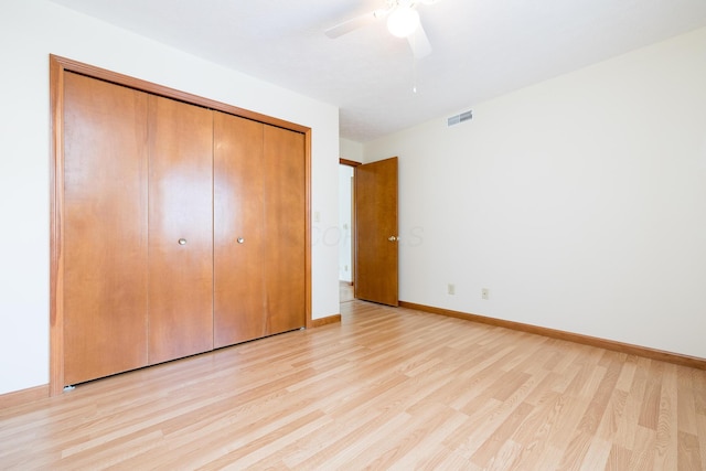 129 Chase Ave Unit 102L, Russells Point, OH 43348 - unfurnished bedroom with light wood-style flooring, a closet, and ceiling fan