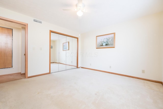 129 Chase Ave Unit 102L, Russells Point, OH 43348 - unfurnished bedroom featuring carpet flooring, a closet, and a ceiling fan