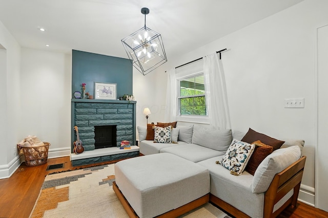 484 Sheldon Ave, Columbus, OH 43207 - living room with a chandelier, wood finished floors, recessed lighting, and a stone fireplace