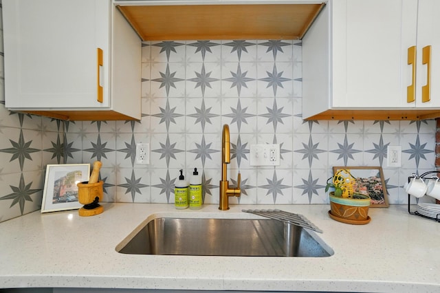484 Sheldon Ave, Columbus, OH 43207 - kitchen with backsplash, white cabinets, and light stone countertops