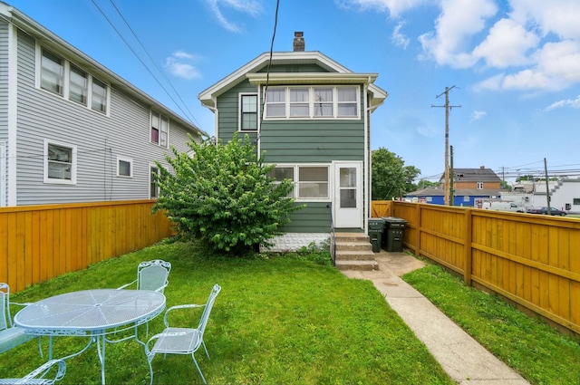 484 Sheldon Ave, Columbus, OH 43207 - back of house featuring a fenced backyard, entry steps, and a chimney