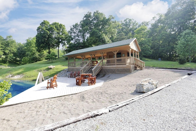 35640 Vickers Rd, Logan, OH 43138 - covered porch with a lawn, view of scattered trees, and a water view