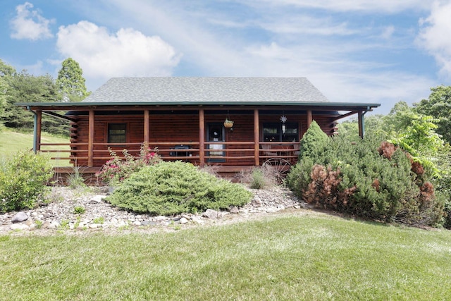 35640 Vickers Rd, Logan, OH 43138 - log cabin with covered porch, log exterior, a front lawn, and roof with shingles