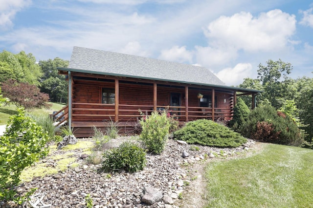 35640 Vickers Rd, Logan, OH 43138 - view of front of property with covered porch, log exterior, and roof with shingles