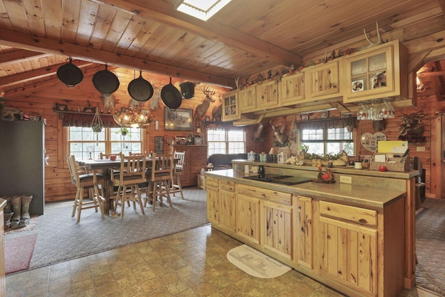 35640 Vickers Rd, Logan, OH 43138 - kitchen with plenty of natural light, wooden walls, black electric cooktop, a wood ceiling with exposed beams, and glass insert cabinets