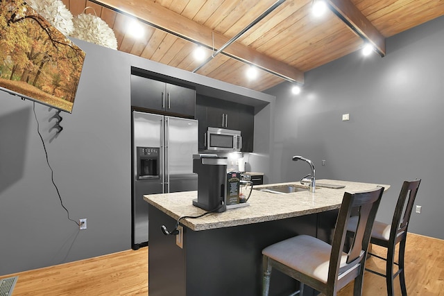 448 W Nationwide Blvd Unit 404, Columbus, OH 43215 - kitchen with stainless steel appliances, dark cabinetry, a wood ceiling with exposed beams, light wood-style flooring, and light countertops