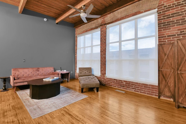 448 W Nationwide Blvd Unit 404, Columbus, OH 43215 - living area with a wooden ceiling with exposed beams, a ceiling fan, wood finished floors, and brick wall