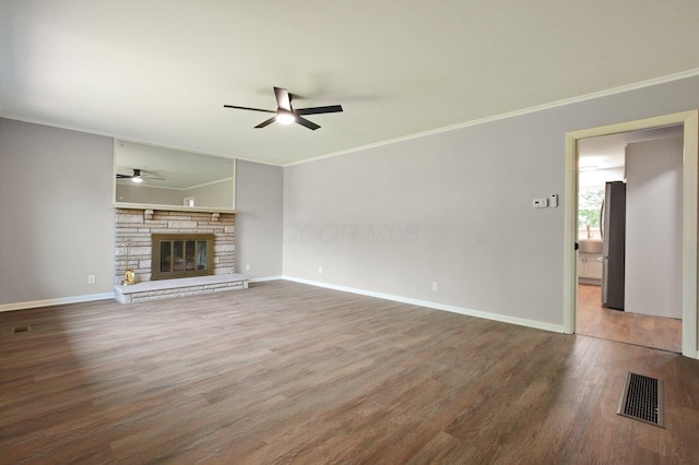 1370 Wiltshire Rd, Columbus, OH 43223 - unfurnished living room with a ceiling fan, ornamental molding, wood finished floors, and a stone fireplace