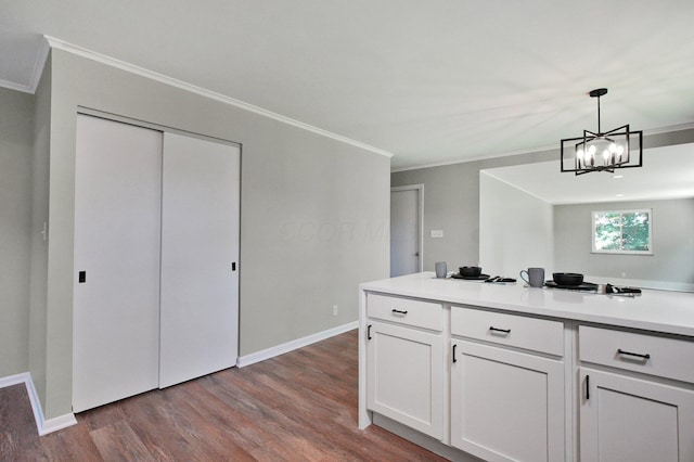 1370 Wiltshire Rd, Columbus, OH 43223 - kitchen with crown molding, dark wood-style flooring, white cabinets, pendant lighting, and light countertops