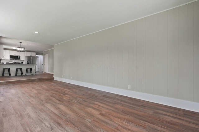 1370 Wiltshire Rd, Columbus, OH 43223 - unfurnished living room with dark wood-style floors, a chandelier, and recessed lighting
