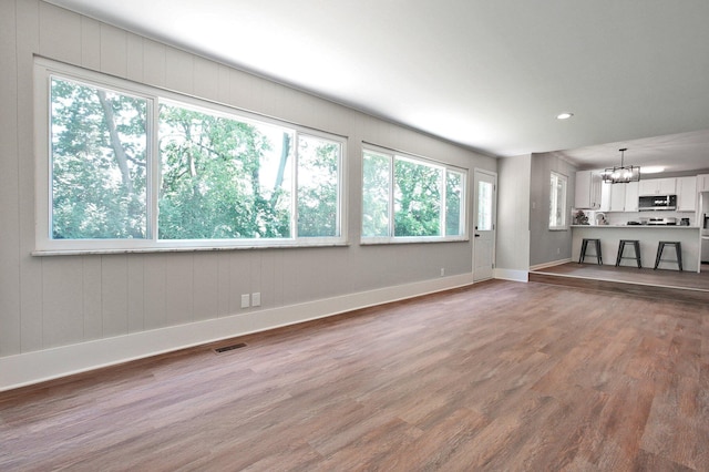 1370 Wiltshire Rd, Columbus, OH 43223 - unfurnished living room with a chandelier, wood finished floors, and recessed lighting
