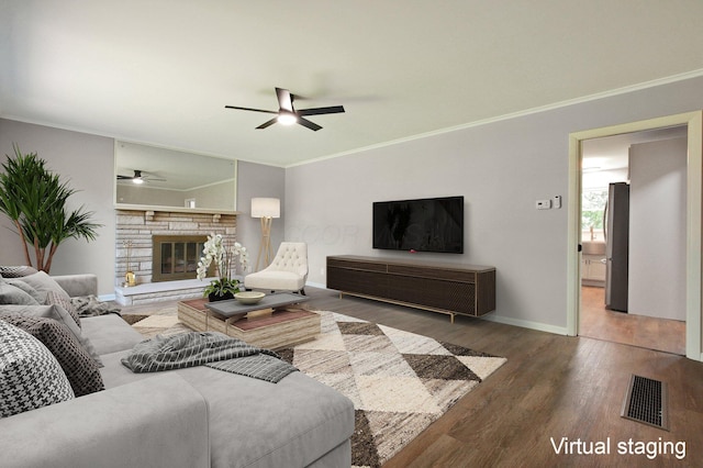 1370 Wiltshire Rd, Columbus, OH 43223 - living room with a ceiling fan, ornamental molding, wood finished floors, and a stone fireplace