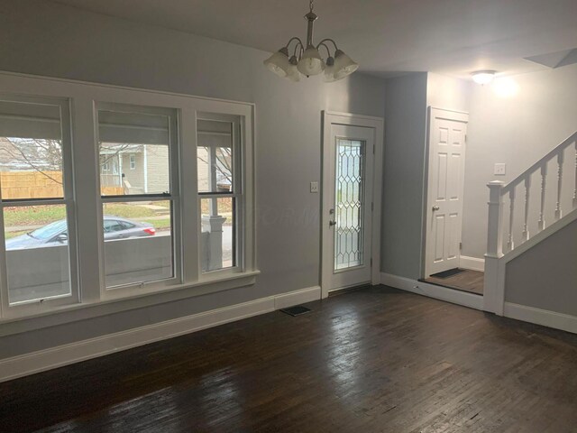 436 S Wayne Ave, Columbus, OH 43204 - foyer with a chandelier, stairs, and dark wood-type flooring