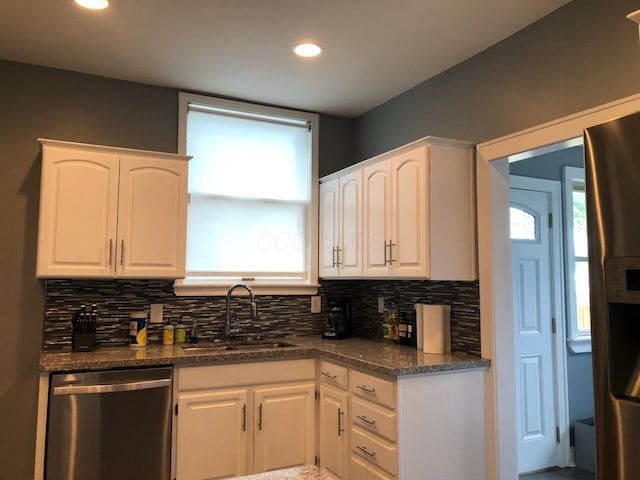 436 S Wayne Ave, Columbus, OH 43204 - kitchen with appliances with stainless steel finishes, backsplash, white cabinets, and recessed lighting