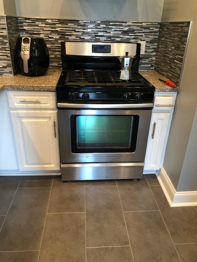 436 S Wayne Ave, Columbus, OH 43204 - detailed view of stainless steel gas range, white cabinetry, and backsplash