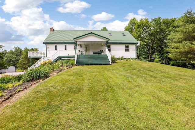 51801 State Route 671, Londonderry, OH 45647 - rear view of house featuring stairs, a chimney, a yard, and a metal roof