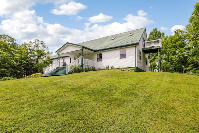 51801 State Route 671, Londonderry, OH 45647 - rear view of house with a lawn, covered porch, and a metal roof