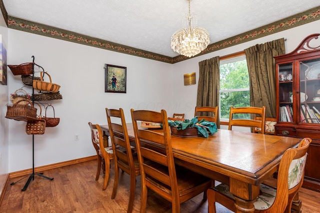 51801 State Route 671, Londonderry, OH 45647 - dining space featuring a chandelier, wood finished floors, and a textured ceiling