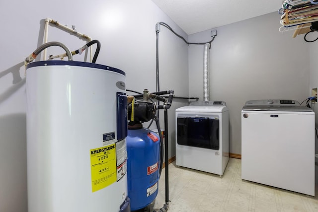 51801 State Route 671, Londonderry, OH 45647 - laundry area with water heater, washer and dryer, and light flooring