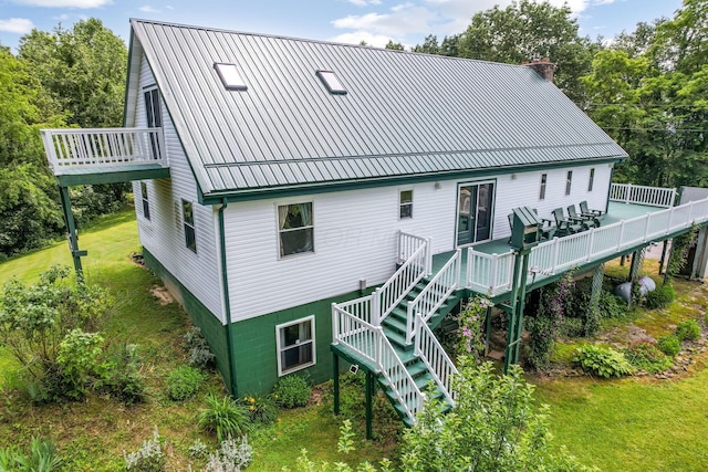 51801 State Route 671, Londonderry, OH 45647 - rear view of house with a wooden deck, stairway, a metal roof, and a chimney