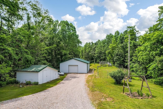 51801 State Route 671, Londonderry, OH 45647 - detached garage with driveway and a view of trees
