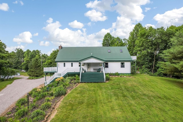 51801 State Route 671, Londonderry, OH 45647 - view of front facade with a chimney, a front lawn, a metal roof, driveway, and stairway