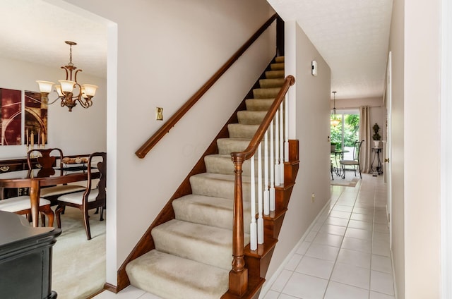 7771 Strathmoore Rd, Dublin, OH 43016 - staircase with a chandelier and tile patterned floors