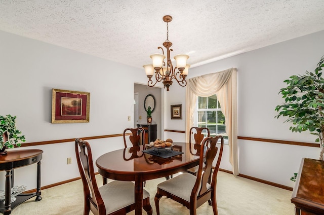 7771 Strathmoore Rd, Dublin, OH 43016 - dining area featuring light carpet, a chandelier, and a textured ceiling