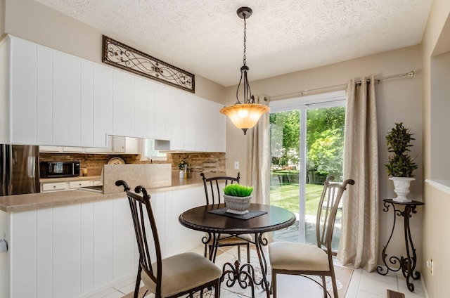 7771 Strathmoore Rd, Dublin, OH 43016 - dining space featuring light tile patterned floors and a textured ceiling