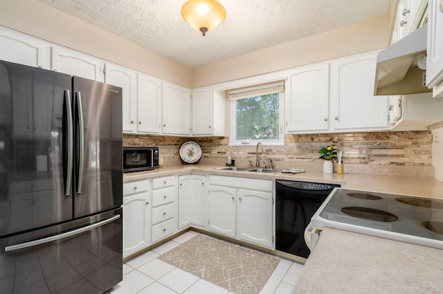 7771 Strathmoore Rd, Dublin, OH 43016 - kitchen with freestanding refrigerator, under cabinet range hood, dishwasher, a textured ceiling, and backsplash