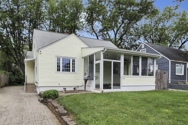 3505 Dresden St, Columbus, OH 43224 - view of front of house with a sunroom and a shingled roof