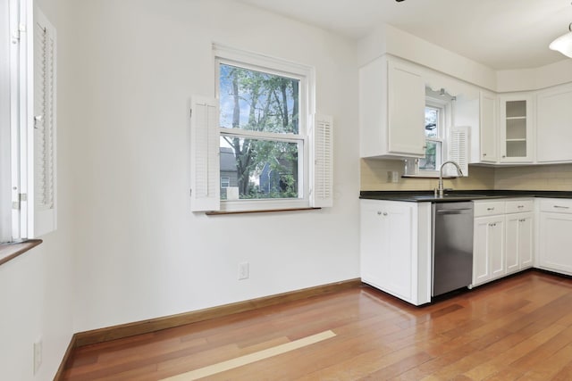 3505 Dresden St, Columbus, OH 43224 - kitchen featuring healthy amount of natural light, stainless steel dishwasher, hardwood / wood-style floors, and white cabinetry
