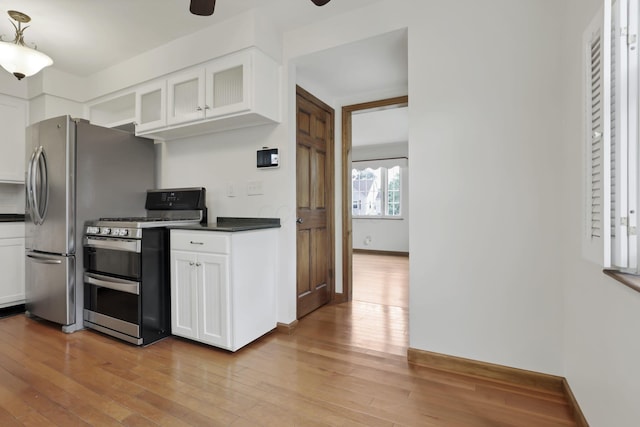 3505 Dresden St, Columbus, OH 43224 - kitchen featuring double oven range, dark countertops, hardwood / wood-style flooring, and white cabinetry