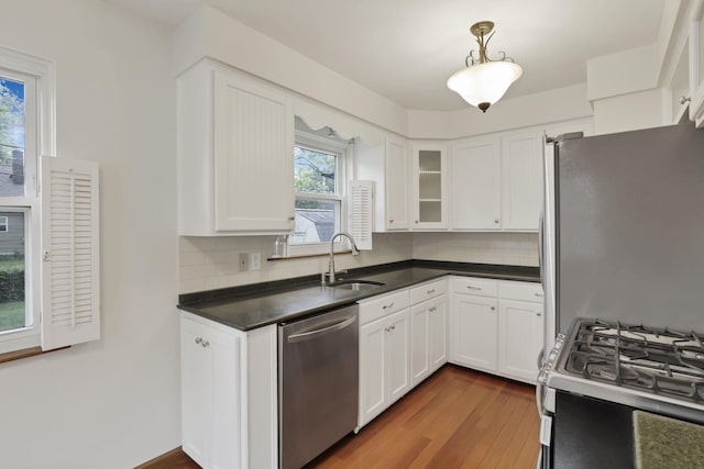 3505 Dresden St, Columbus, OH 43224 - kitchen featuring appliances with stainless steel finishes, white cabinets, tasteful backsplash, and dark countertops