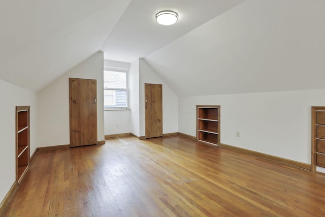 3505 Dresden St, Columbus, OH 43224 - bonus room with hardwood / wood-style flooring, vaulted ceiling, and built in shelves