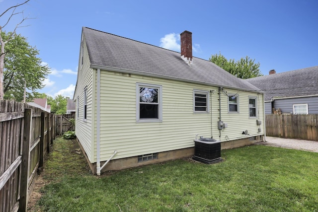 3505 Dresden St, Columbus, OH 43224 - rear view of house with a fenced backyard, a chimney, roof with shingles, and a patio