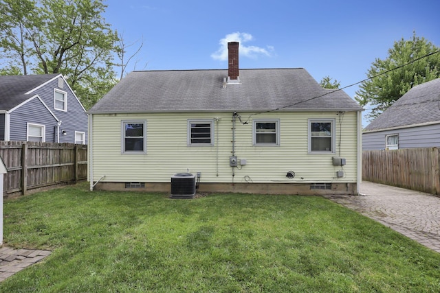 3505 Dresden St, Columbus, OH 43224 - rear view of house featuring a chimney, a fenced backyard, and a shingled roof