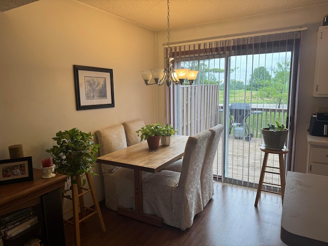 4830 Stoneybrook Blvd Unit 28E, Hilliard, OH 43026 - dining space featuring a chandelier, dark wood-style flooring, and a textured ceiling