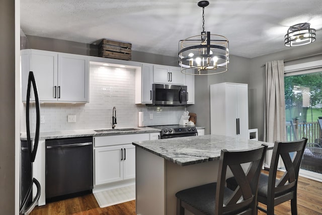 4634 State Route 61, Sunbury, OH 43074 - kitchen with stainless steel appliances, backsplash, a kitchen breakfast bar, and dark wood-style floors